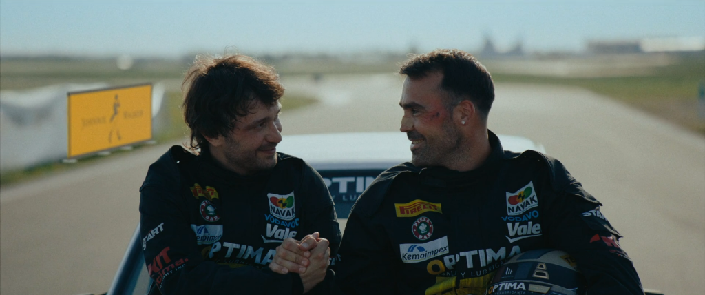Scene from “First Class – Full Throttle” (2024) Two rival drivers sharing a moment of friendship